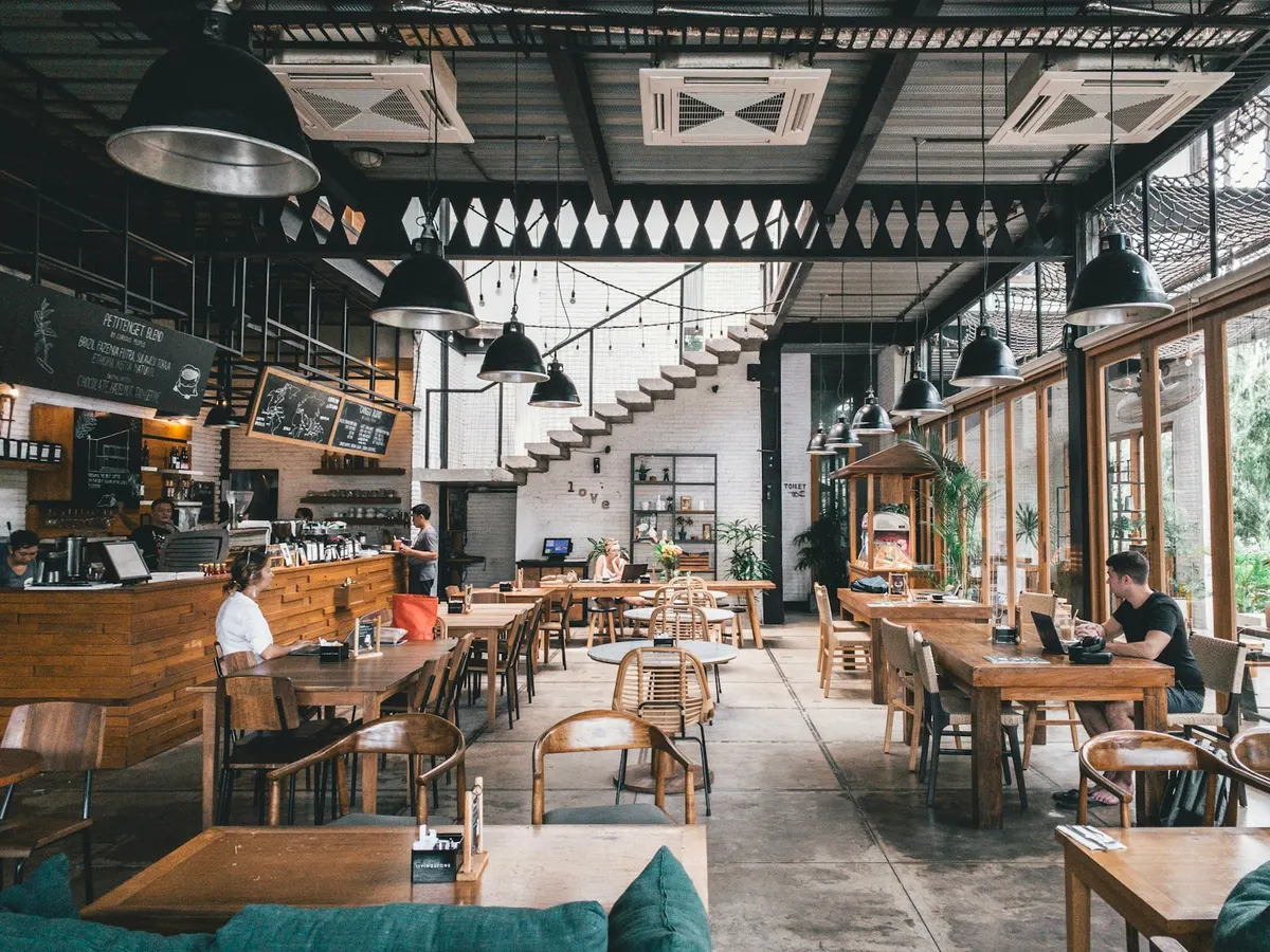 Busy restaurant dining area with tables and a service counter