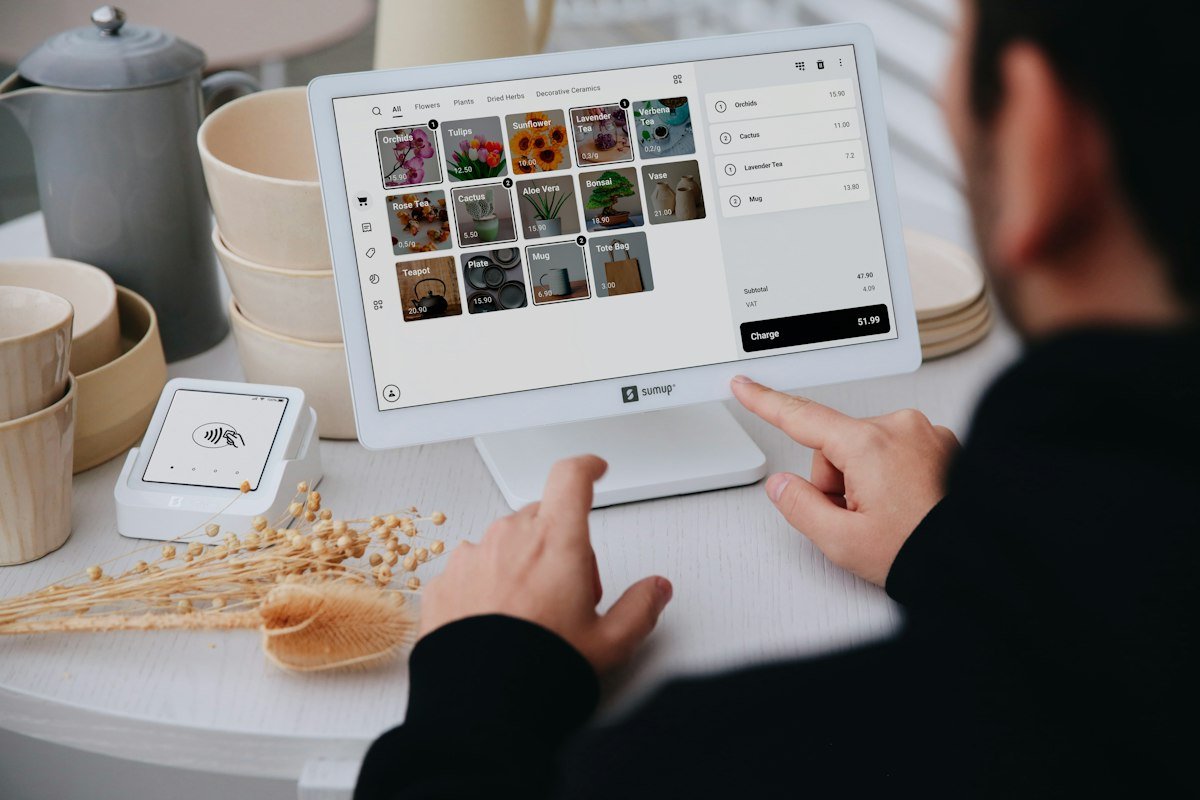 Business owner using a POS system at checkout